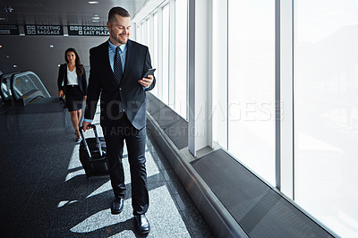 Buy stock photo Business man, woman and smartphone in airport hallway with smile, thinking or suitcase for international travel. Entrepreneur, luggage and phone with flight schedule for global immigration in London