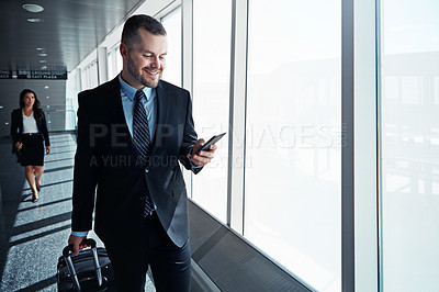 Buy stock photo Business man, phone and travel in airport window for reading, thinking and contact in corridor with smile. Entrepreneur, luggage and smartphone for flight schedule and global immigration in London