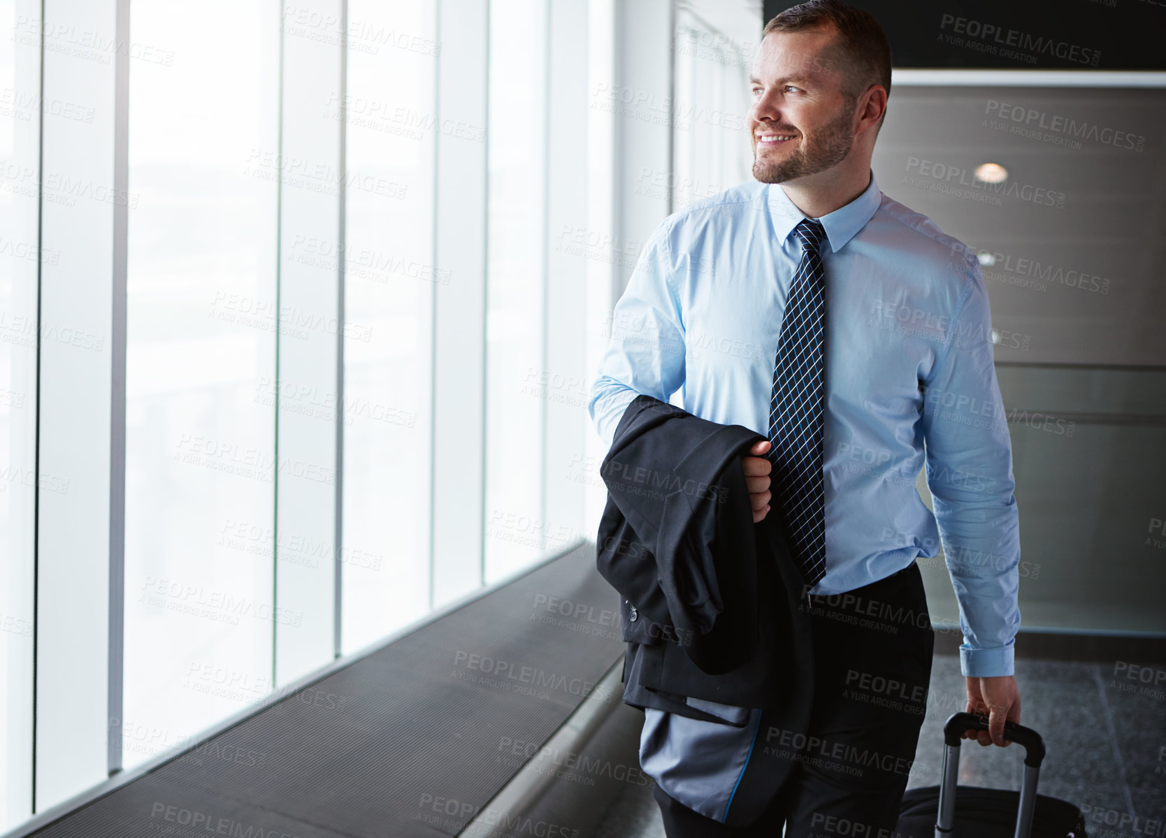 Buy stock photo Walking, manager or businessman in airport thinking of company trip with suitcase or luggage. Happy, window or corporate worker in hallway for commute journey or international travel with pride 