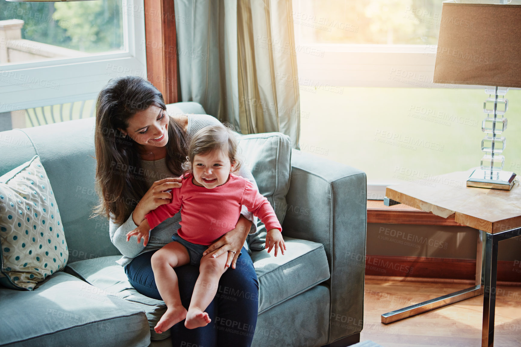 Buy stock photo Relax, happy and smile with mother and baby on sofa for bonding, quality time and child development. Growth, support and trust with mom and daughter in family home for health, connection and care