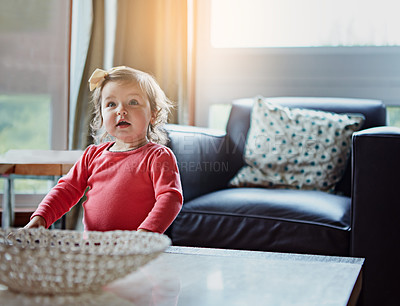 Buy stock photo Children, baby and a girl in the living room of her home with mockup or flare looking curious while standing alone. Kids, development and lifestyle with a cute female child in a house during the day