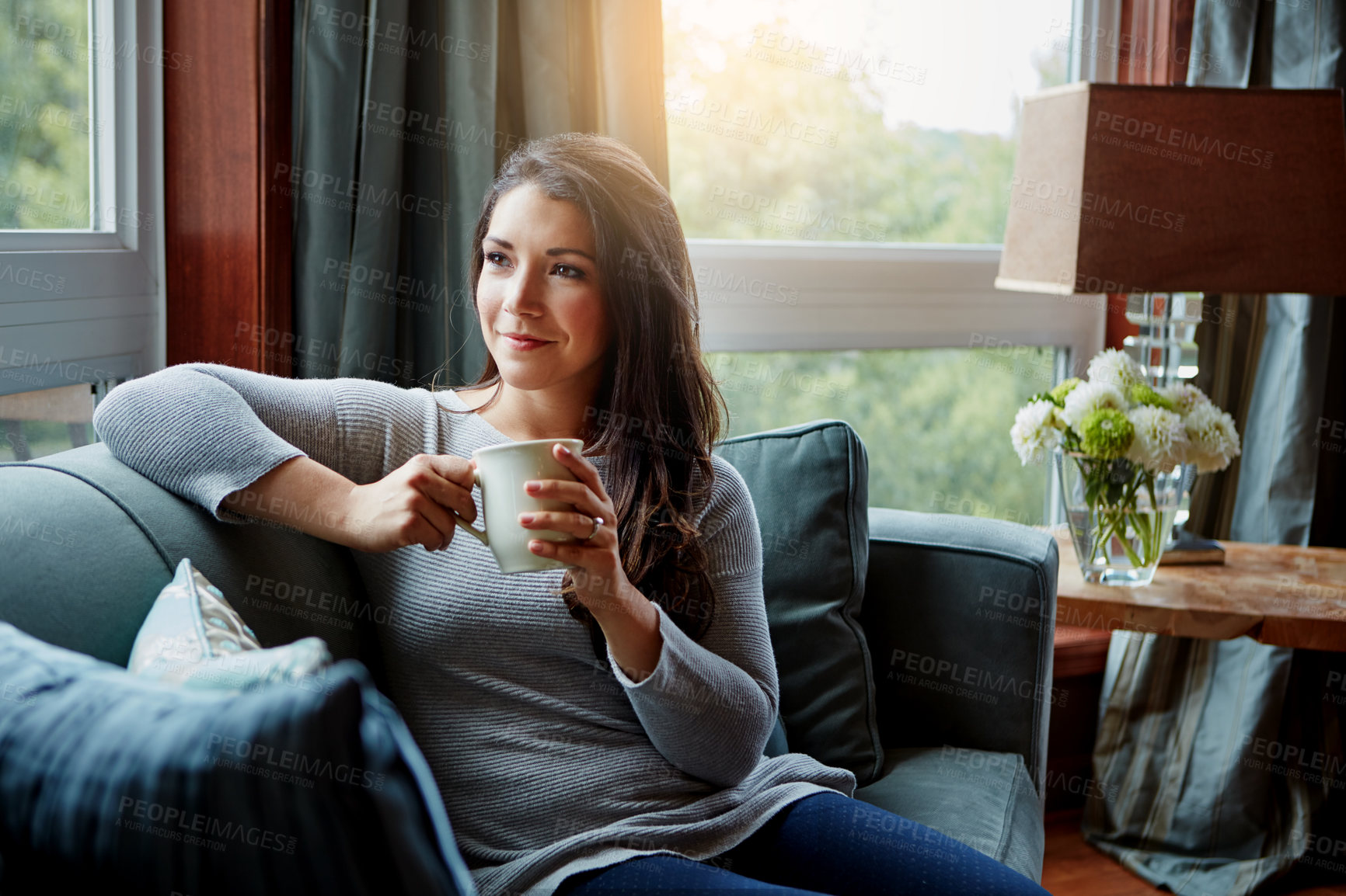 Buy stock photo Shot of an attractive young woman relaxing at home