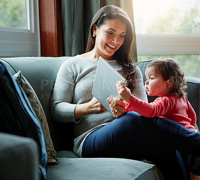 Buy stock photo Mother, tablet and baby on living room sofa for entertainment, bonding or time together at home. Happy mom with cute little daughter, child or kid relaxing on the couch with touchscreen at the house