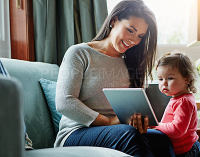 Buy stock photo Education, mother and child with tablet in living room together for internet connection and development in home. Woman, kid or daughter with tech on couch for online learning and studying with love