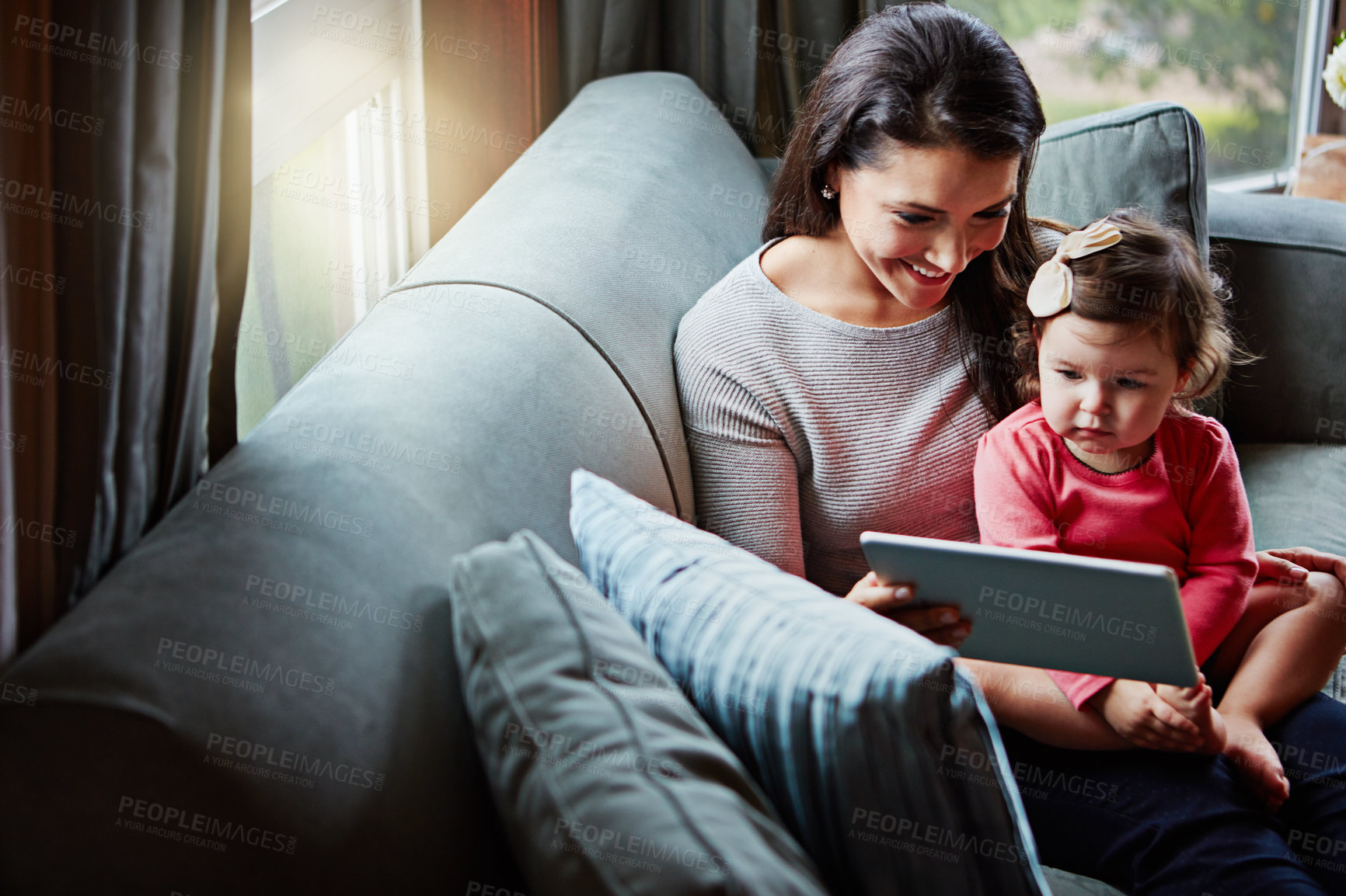 Buy stock photo Education, mother and child with tablet on sofa together for internet connection and development in home. Woman, kid or daughter with tech on couch for online learning and studying with love