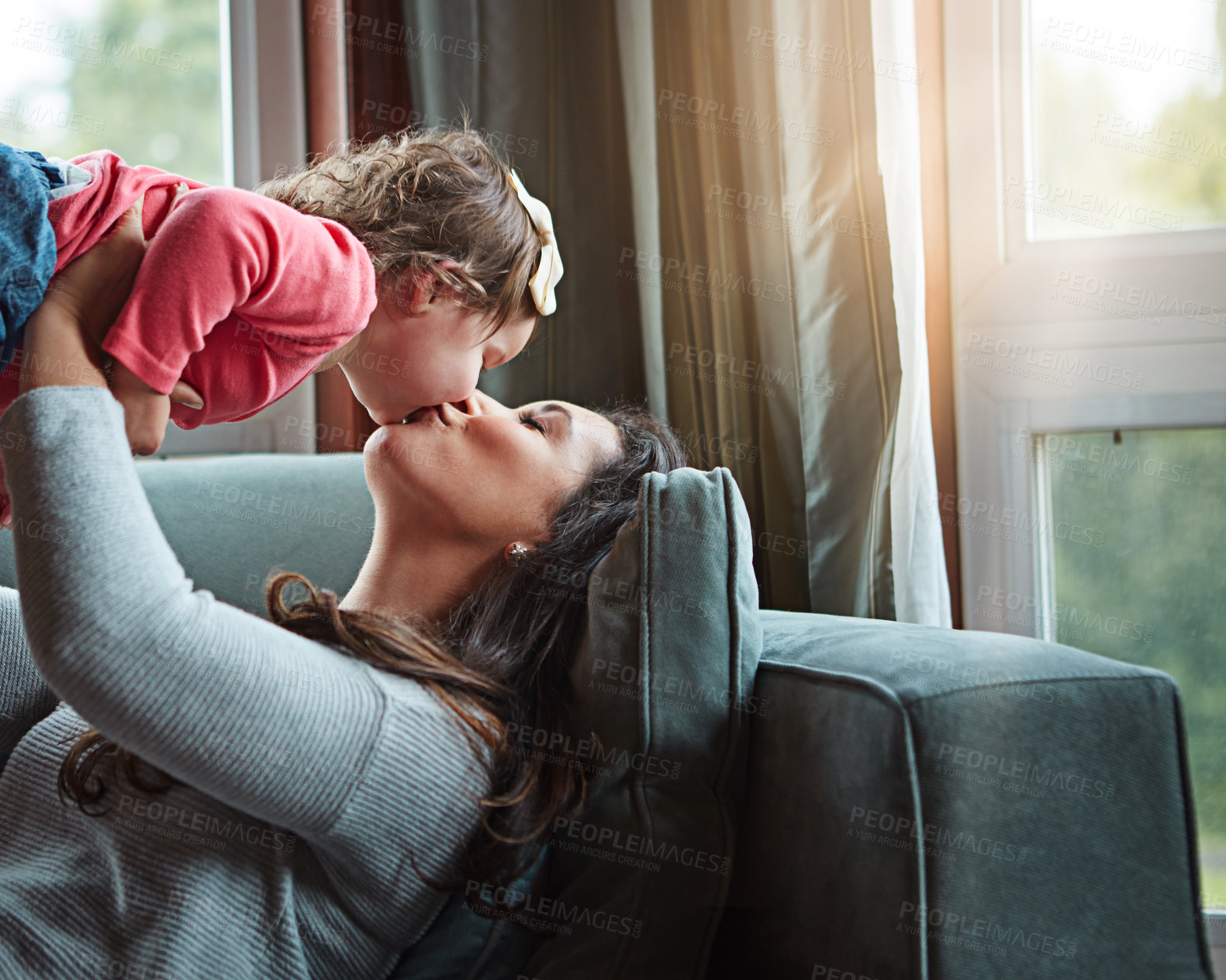 Buy stock photo Relax, happy and kiss with mother and baby on sofa for bonding, quality time and child development. Growth, support and trust with mom and daughter in family home for health, connection and care