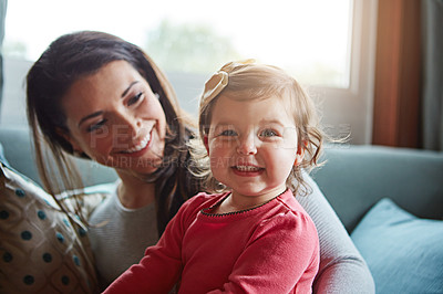 Buy stock photo Shot of a mother bonding with her adorable little daughter at home