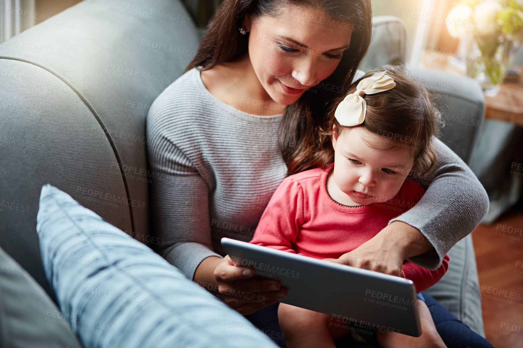 Buy stock photo Family, baby and tablet with a mother and daughter sitting on a sofa in the living room of their home for development. Kids, education or overhead with a woman and girl child learning in a house