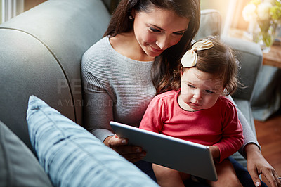Buy stock photo Mother, baby and tablet on sofa watching educational video online on streaming service in home. Love, family time and woman with girl child smile on couch to watch kids movie or cartoon on website.