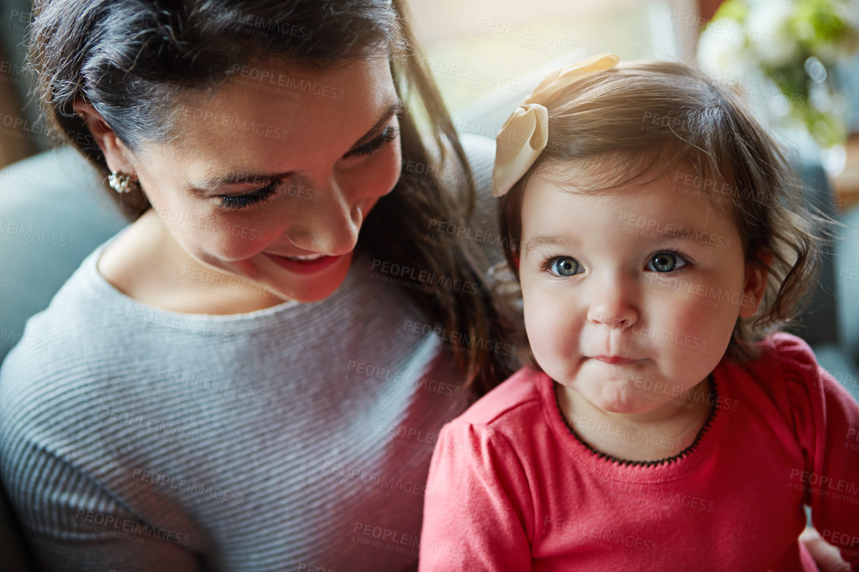 Buy stock photo Mother, child and relax or happy in home with resting, bonding and love with embrace or fun together. Family, woman and daughter or kid with smile for trust, care or security in living room of house