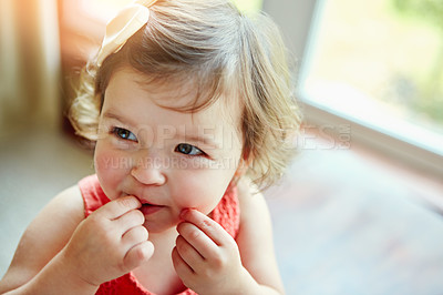 Buy stock photo Happy, baby and girl playing in her home, looking, taste and curious while biting her hand. Child, smile and child development by little girl watching, calm and content in a living room alone 