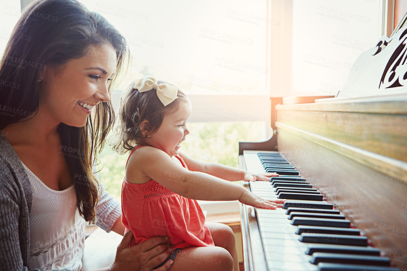 Buy stock photo Mom, toddler and happy for learning by piano with help, care or bonding for love in family home. Girl, mother and daughter by keyboard for music, teaching or playing for development with art in house