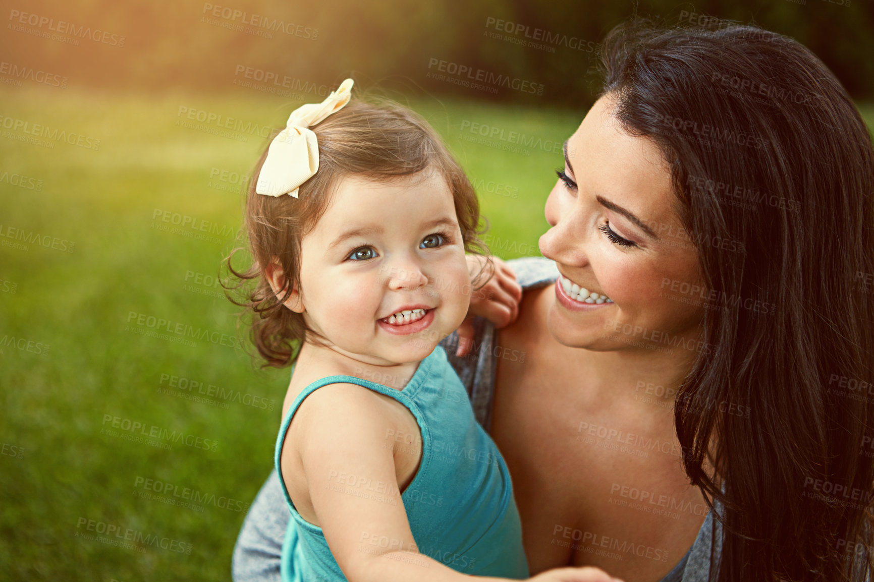 Buy stock photo Cropped shot of a mother bonding with her adorable little daughter outside