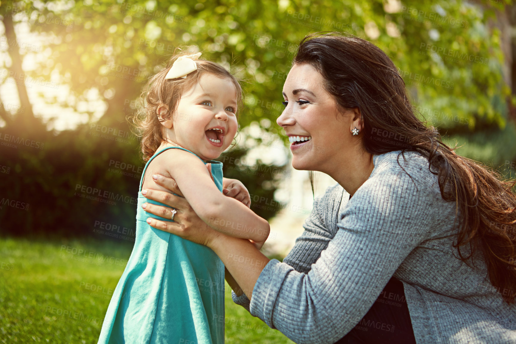 Buy stock photo Cropped shot of a mother bonding with her adorable little daughter outside