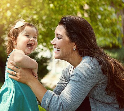 Buy stock photo Cropped shot of a mother bonding with her adorable little daughter outside