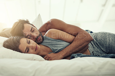 Buy stock photo Cropped shot of an affectionate young couple sleeping in their bed