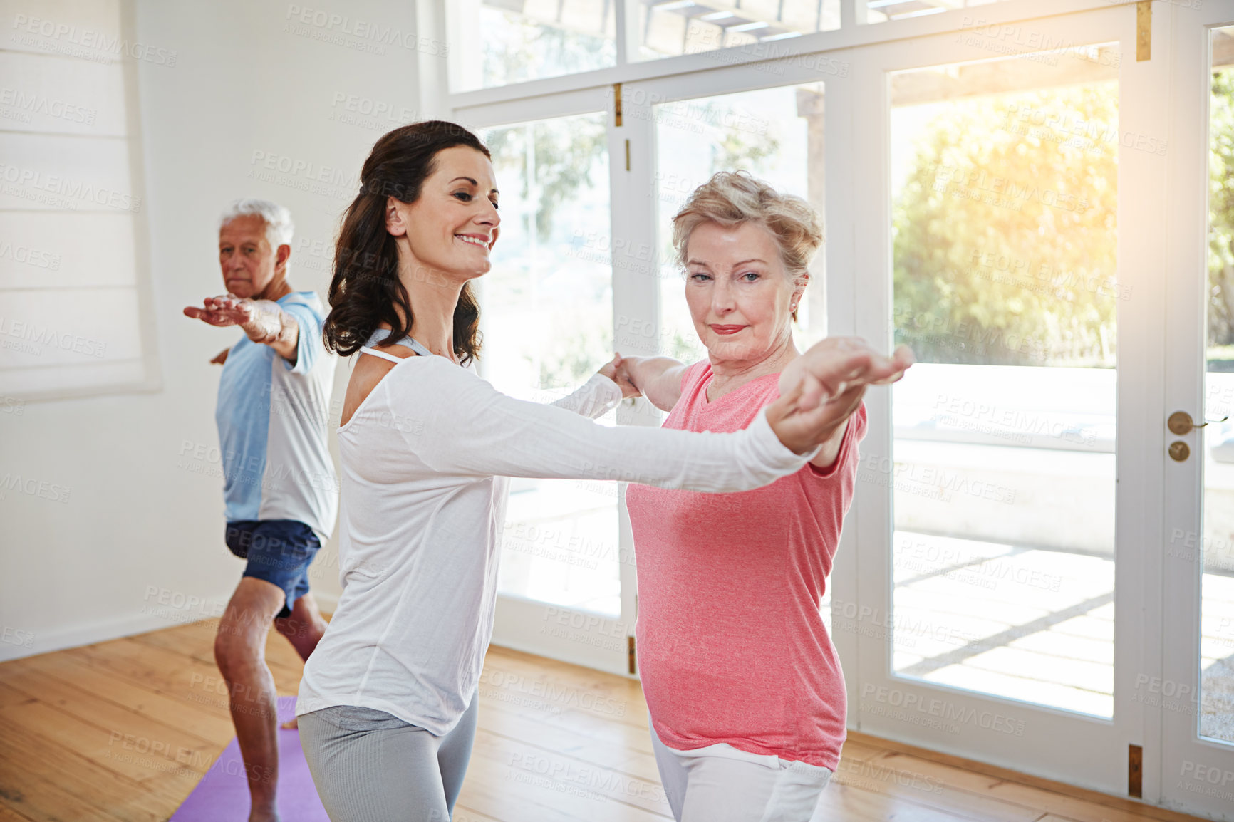 Buy stock photo Yoga, help and senior couple with instructor for fitness, health and wellness in warrior pose in class. Workout, mature man and woman on mat for body care, balance and exercise together with teacher