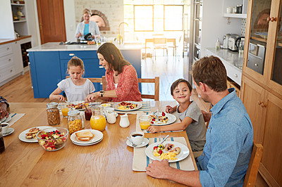 Buy stock photo Food, morning and a family eating breakfast in the dining room of their home together from above. Mother, father and sibling children sitting at a table in their apartment for love or bonding