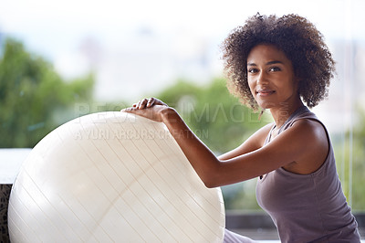 Buy stock photo Cropped portrait of an attractive young woman sitting with an exercise ball