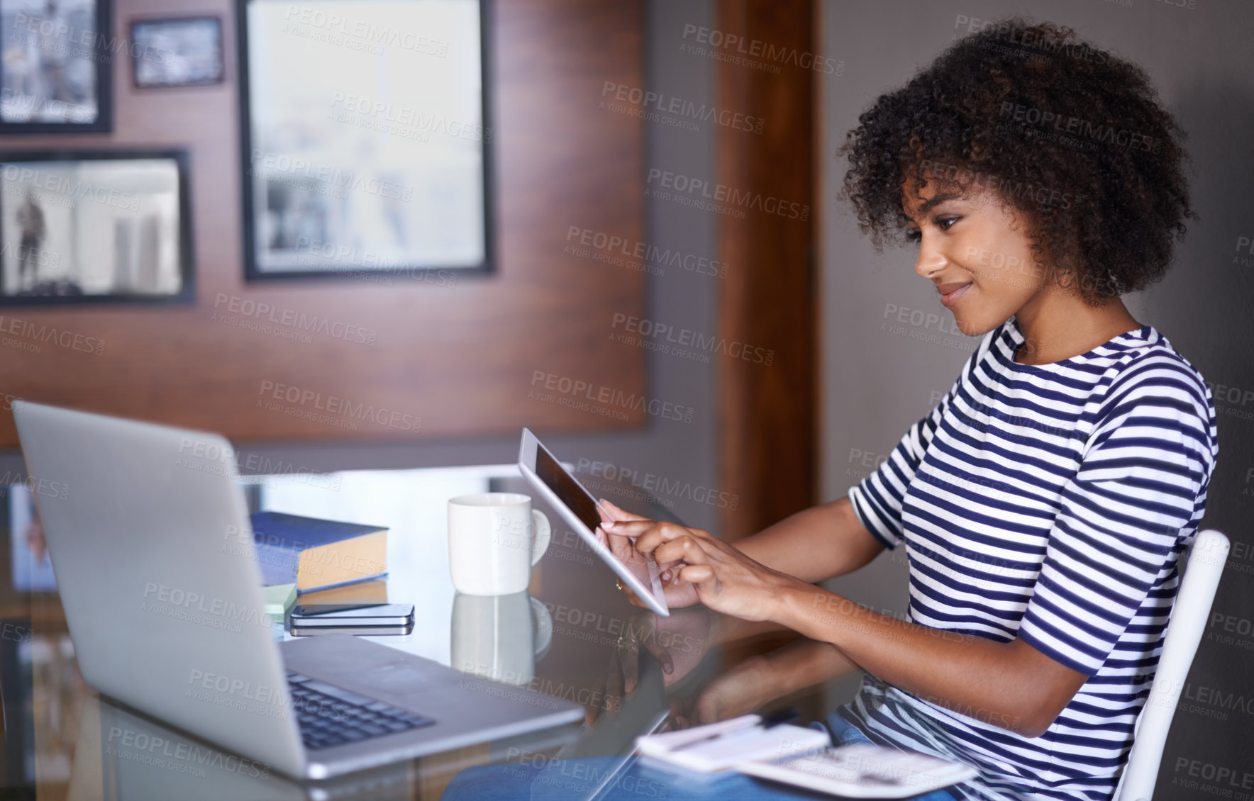 Buy stock photo Cropped shot of an attractive young woman working at home