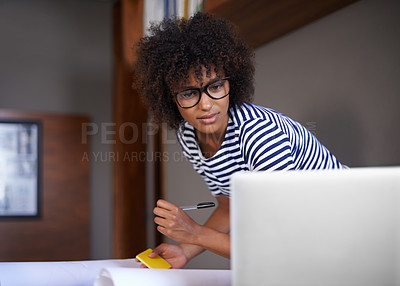 Buy stock photo Cropped shot of an attractive young woman working at home