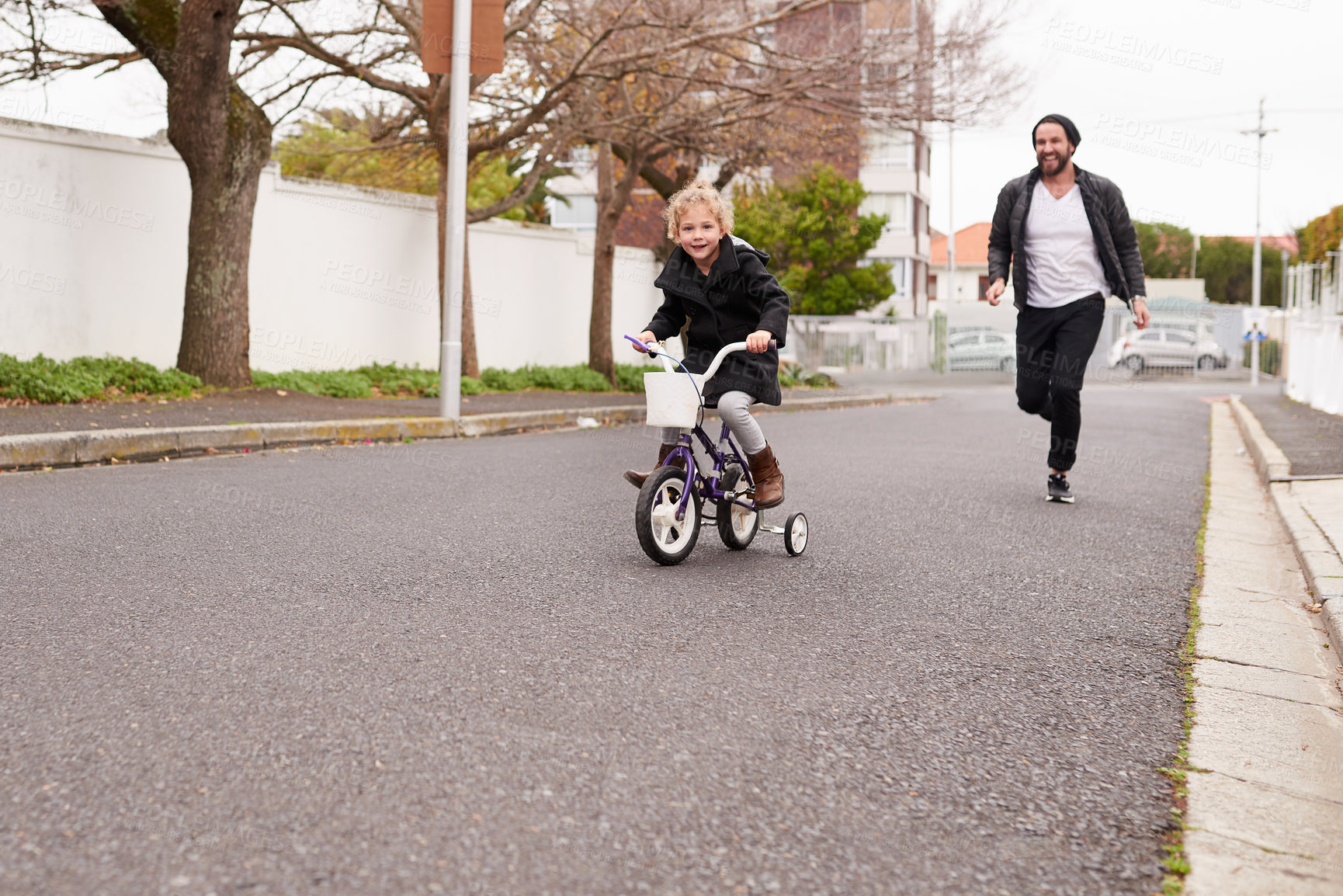 Buy stock photo Father, child and teaching bicycle for safety, street and having fun learning to cycle. Childhood, cycling for development and helping kid ride bike, bonding together and recreation for training