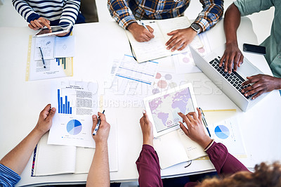 Buy stock photo High angle shot of a team of designers having a meeting together in an office