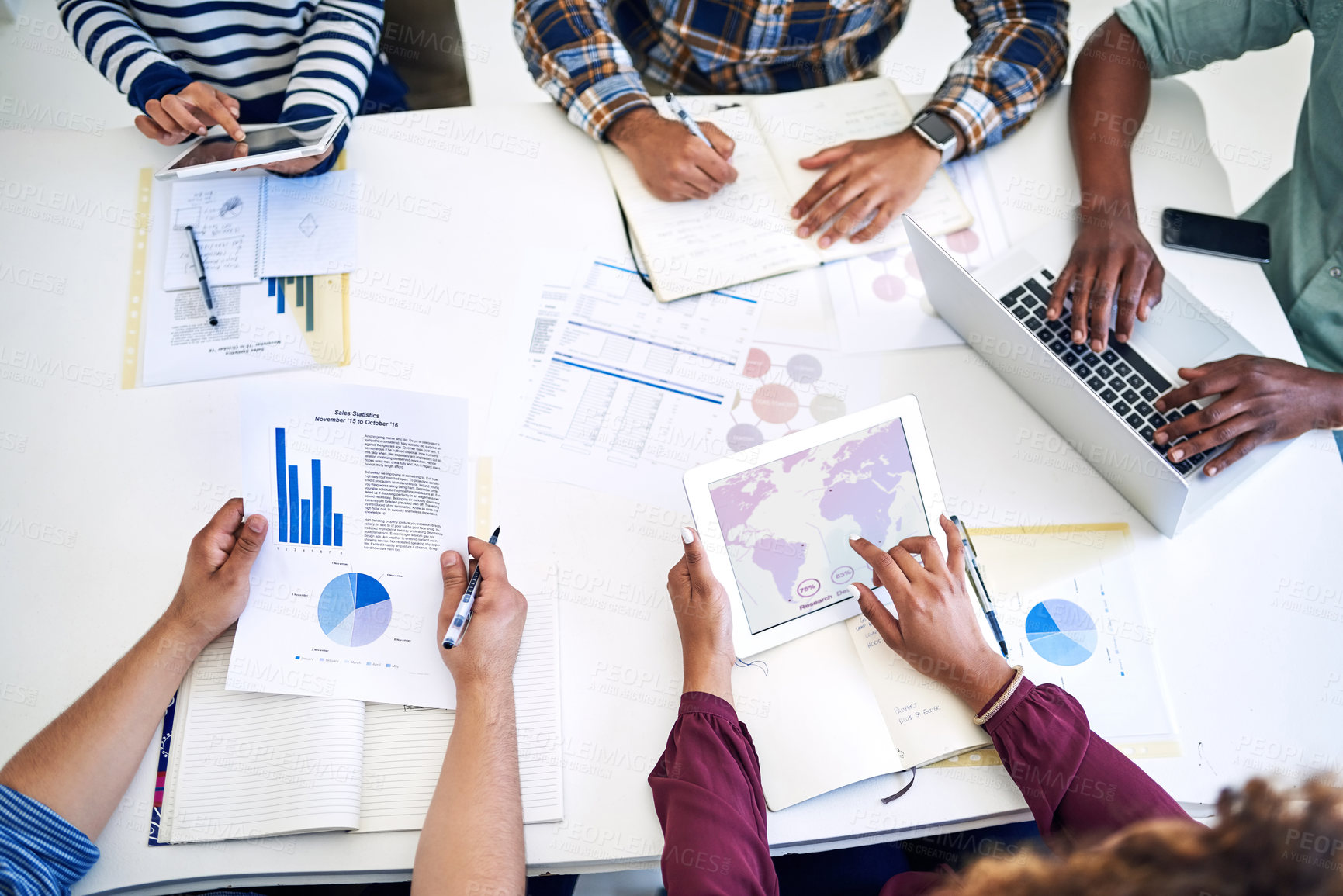 Buy stock photo High angle shot of a team of designers having a meeting together in an office