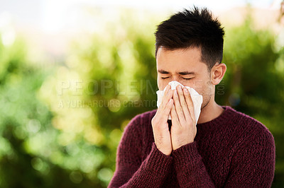 Buy stock photo Man, outdoor and sick with tissue for allergies or pollen, risk of covid or bacteria particles. Male person, eyes closed and blowing nose for virus in nature with care, hands for wellness or health