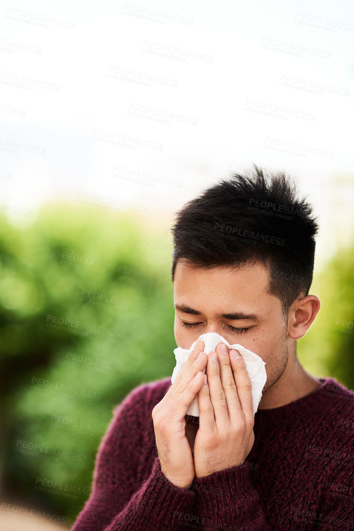 Buy stock photo Man, outdoor and ill with tissue for allergies or pollen, risk of covid or bacteria particles. Male person, eyes closed and blowing nose for virus in nature with care, hands for wellness or health