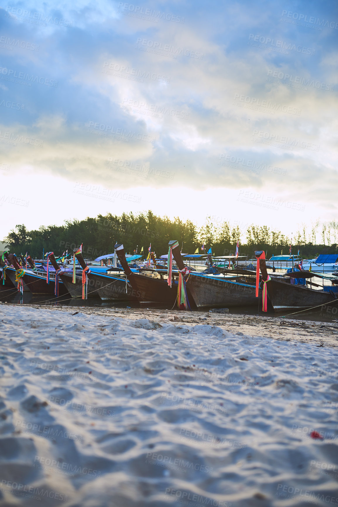 Buy stock photo Shot of traditional wooden boats resting on a beach in Thailand