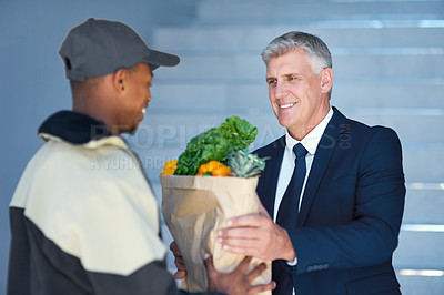 Buy stock photo Portrait of a courier making a grocery delivery to a businessman at work