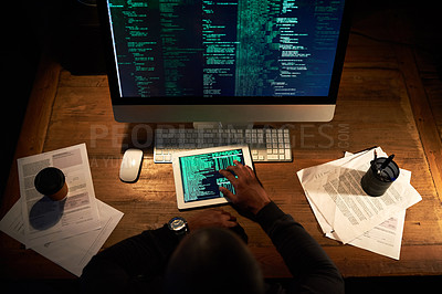 Buy stock photo High angle shot of an unrecognizable man coding on his tablet in the office