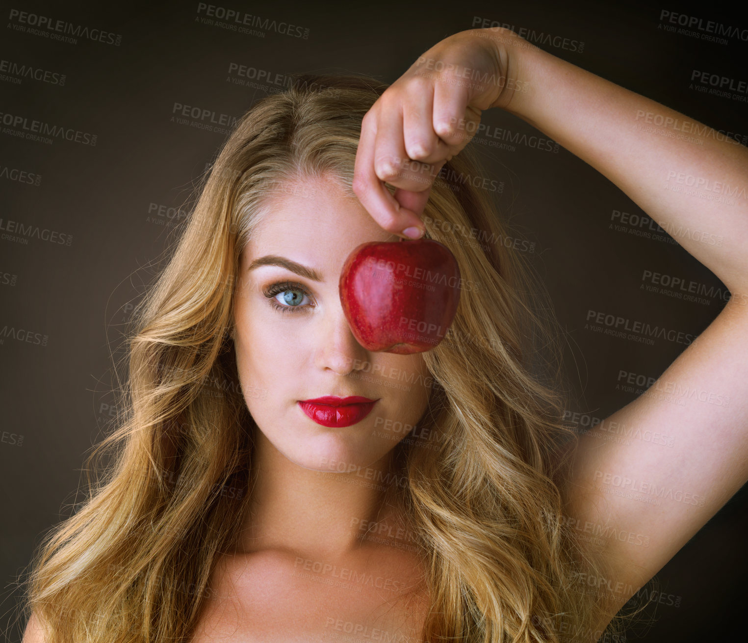 Buy stock photo Portrait, red apple and woman with beauty, makeup and cosmetics on dark studio background. Face, person and girl with fruit, glamour and lipstick with color, shine and aesthetic with glow and luxury