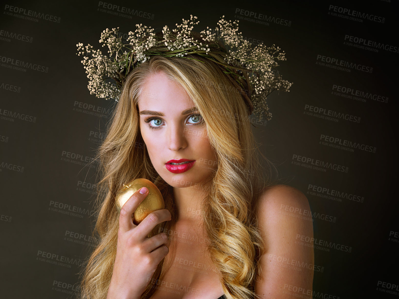 Buy stock photo Portrait, beauty and woman with gold apple isolated on black studio background. Face, food and girl eating forbidden fruit for magic, temptation or sin of model in flower wreath with makeup cosmetics