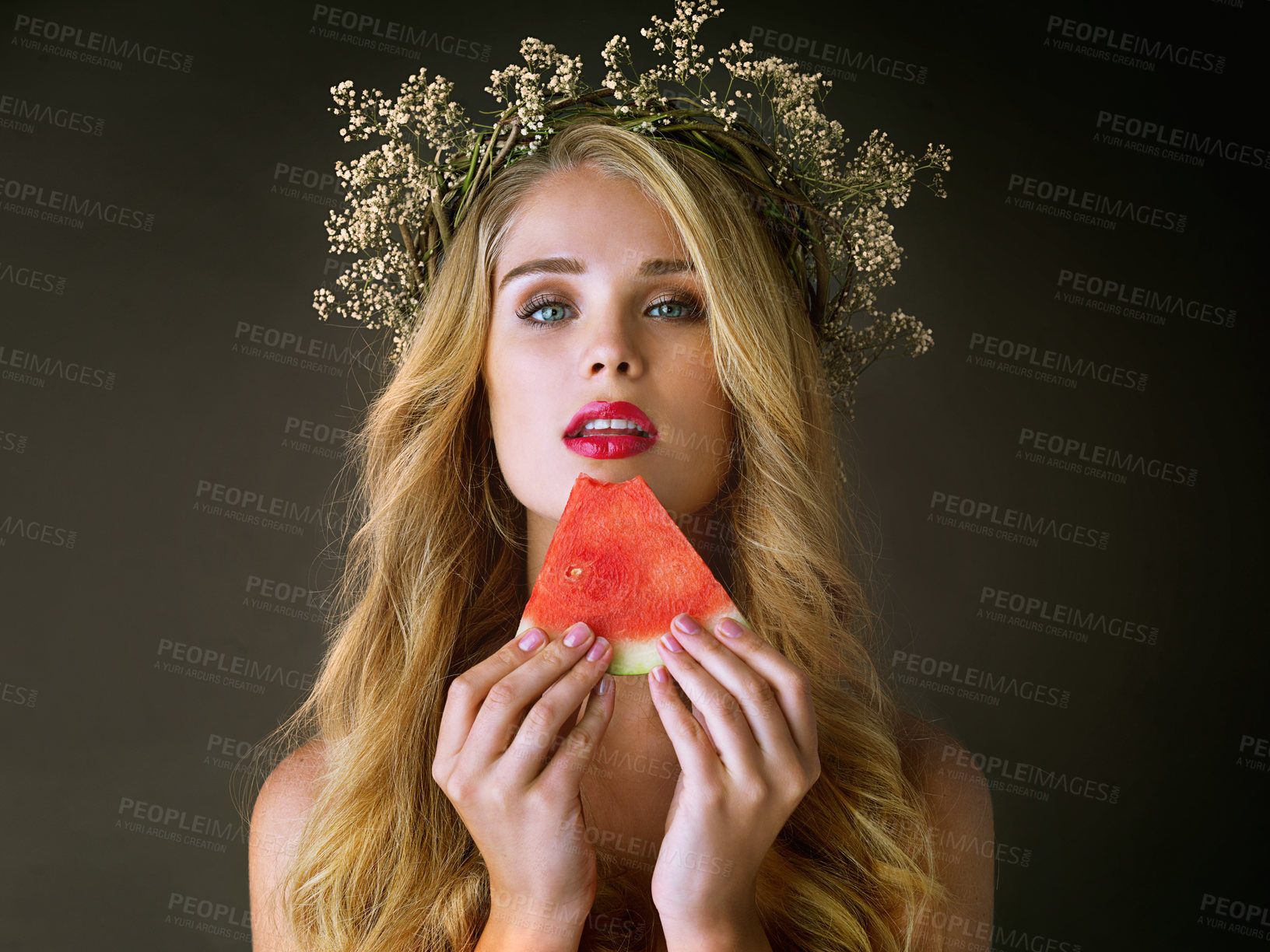 Buy stock photo Makeup, woman and beauty portrait with watermelon for forbidden fruit, desire and temptation with cosmetics. Aphrodite, girl goddess and flower crown with lipstick and eating on studio background