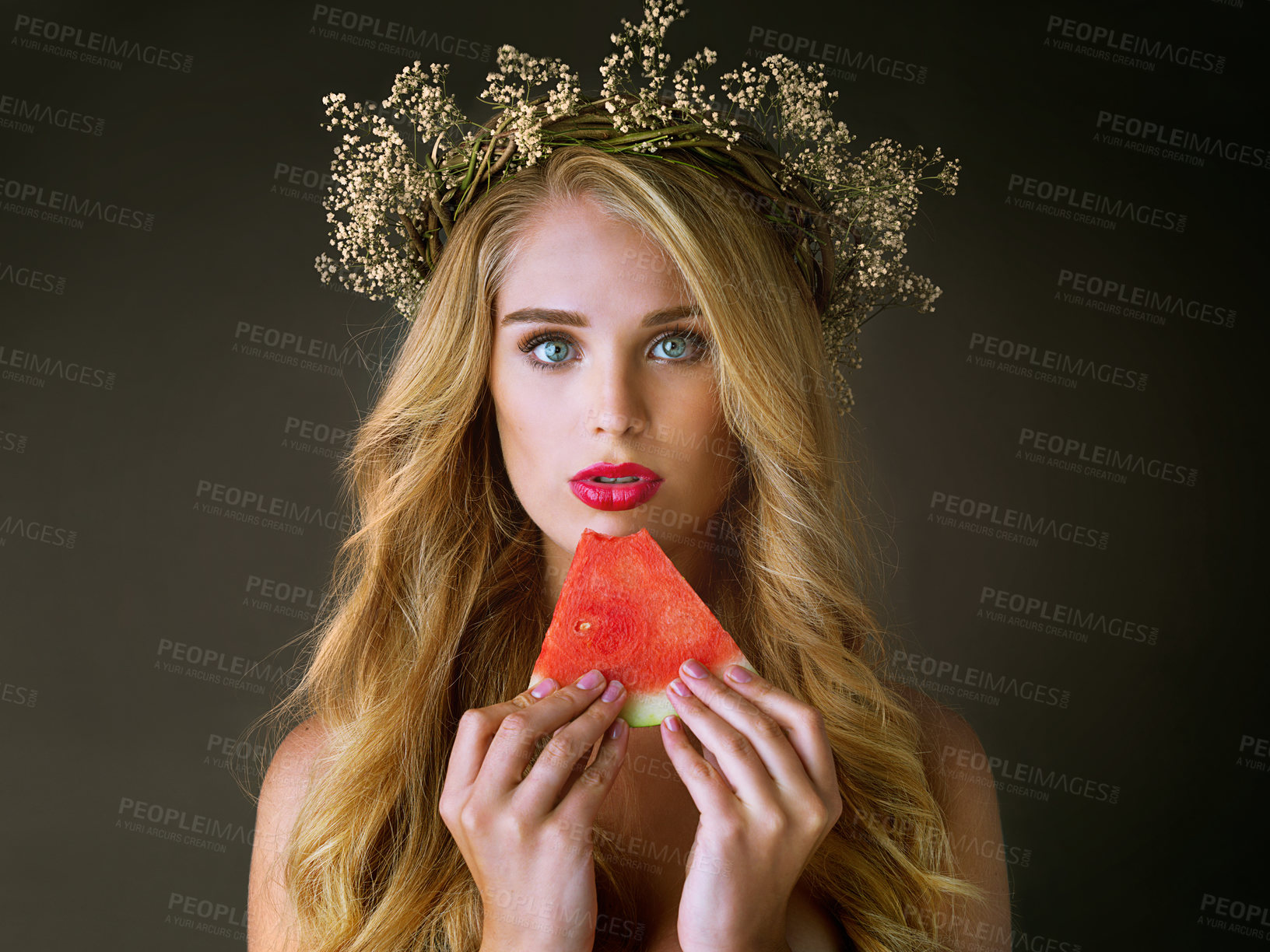 Buy stock photo Makeup, girl and beauty portrait with watermelon for forbidden fruit, desire and temptation with cosmetics. Aphrodite, woman goddess and flower crown with lipstick and eating on studio background