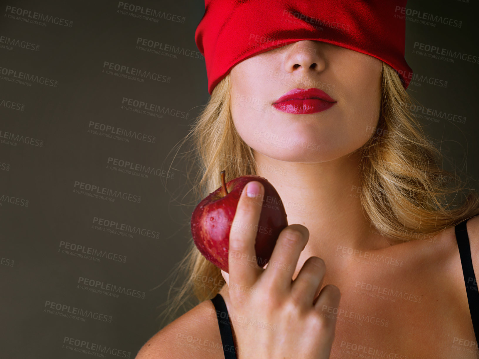 Buy stock photo Apple, sexy and woman seductive in studio with blindfold, bold beauty and red lipstick for nutrition health. Female person, mysterious and erotic food with forbidden fruit on black background