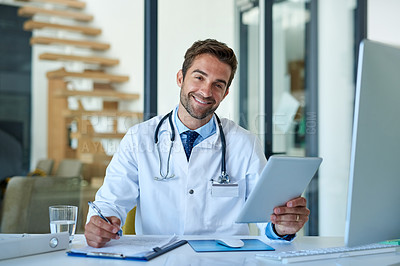 Buy stock photo Portrait of a young doctor working on a digital tablet in his office