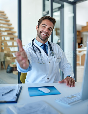 Buy stock photo Portrait of a young doctor extending a handshake in his office