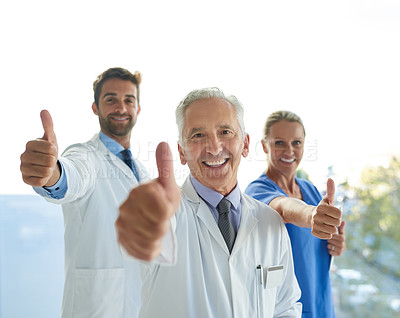 Buy stock photo Portrait of a group of medical practitioners showing thumbs up together