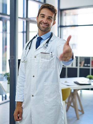 Buy stock photo Portrait of a young doctor extending a handshake in his office