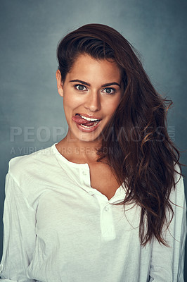 Buy stock photo Funny face, tongue and portrait of woman, silly and confident by backdrop, hair and casual fashion. Happy female person, beauty and cosmetics or goofy, care and joke or posing, comedy and crazy