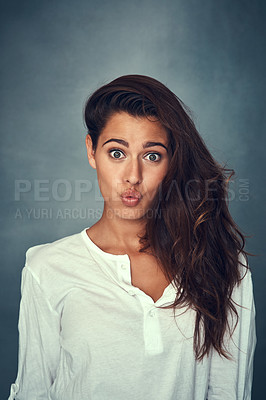 Buy stock photo Pout and comedy in portrait, woman and confident by backdrop, hair and face for casual fashion. Silly female person, beauty and cosmetic or goofy, funny and emoji or wellness by gray background