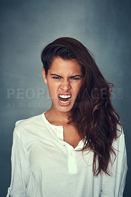 Buy stock photo Growl, face and scream in portrait, woman and confident by backdrop, scary and tough or mean. Filipino female person, fashion and angry or silly, attitude and serious or frown, crazy and alone