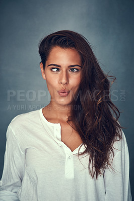 Buy stock photo Funny face, comedy and silly woman or confident by backdrop, hair and casual fashion. Happy female model person, beauty and cosmetics or goofy, positive and joke or pose, kiss and crazy or pout