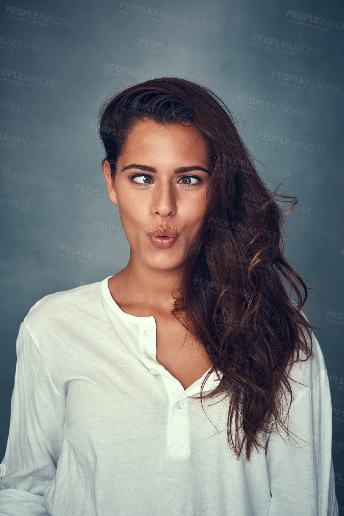 Buy stock photo Funny face, comedy and silly woman or confident by backdrop, hair and casual fashion. Happy female model person, beauty and cosmetics or goofy, positive and joke or pose, kiss and crazy or pout