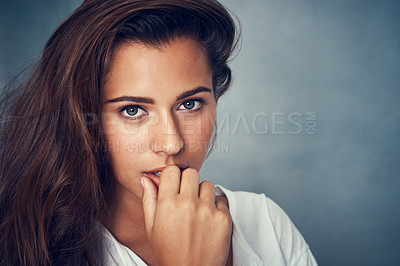Buy stock photo Portrait of a beautiful young woman posing against a gray background in studio