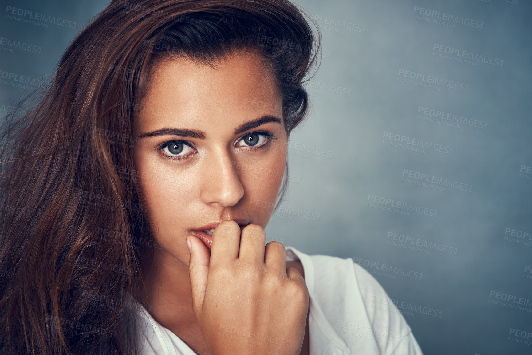 Buy stock photo Portrait of a beautiful young woman posing against a gray background in studio