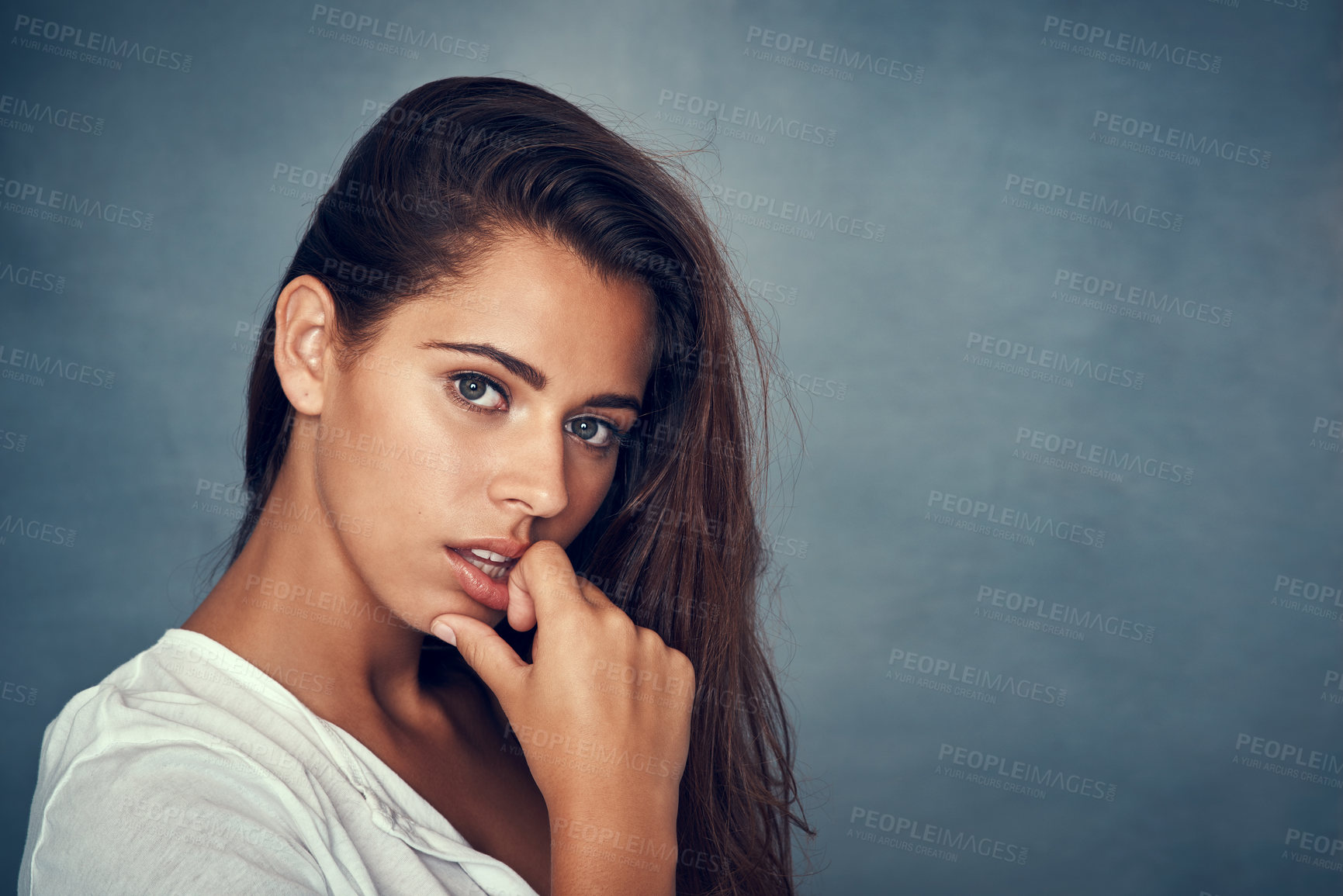 Buy stock photo Portrait of a beautiful young woman posing against a gray background in studio